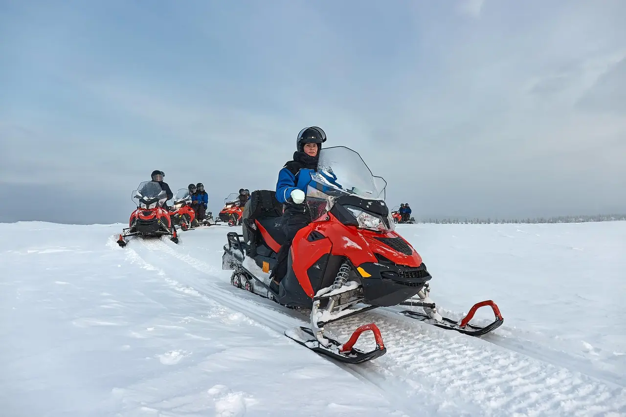 Snowmobile tour across frozen tundra and forests